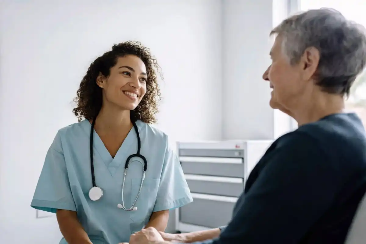Healthcare provider speaking with a patient during a routine visit