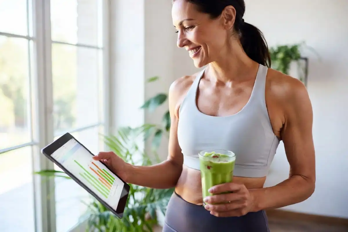 Happy woman tracking wellness progress on Brello Health app