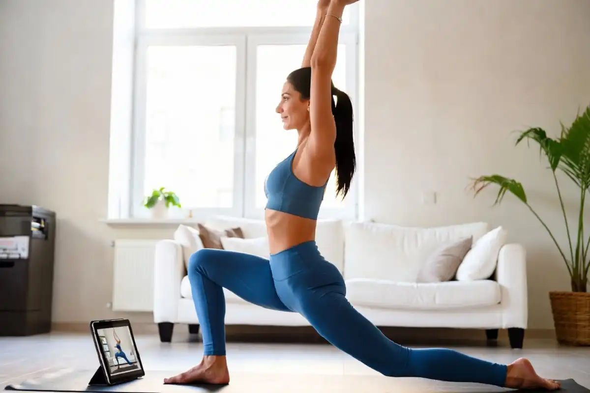 Woman doing yoga at home as part of Brello Rise wellness program