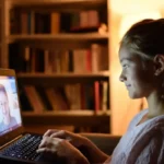 Teenager in a Charlie Health virtual IOP therapy session on a laptop at home