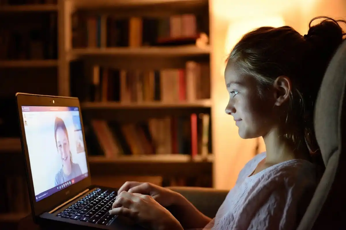 Teenager in a Charlie Health virtual IOP therapy session on a laptop at home