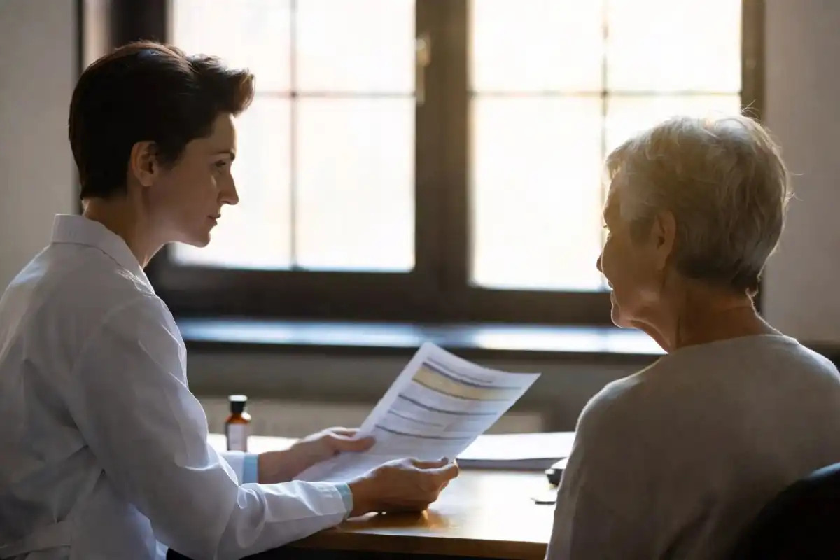 A practitioner reviewing designs for health supplement recommendations with a patient