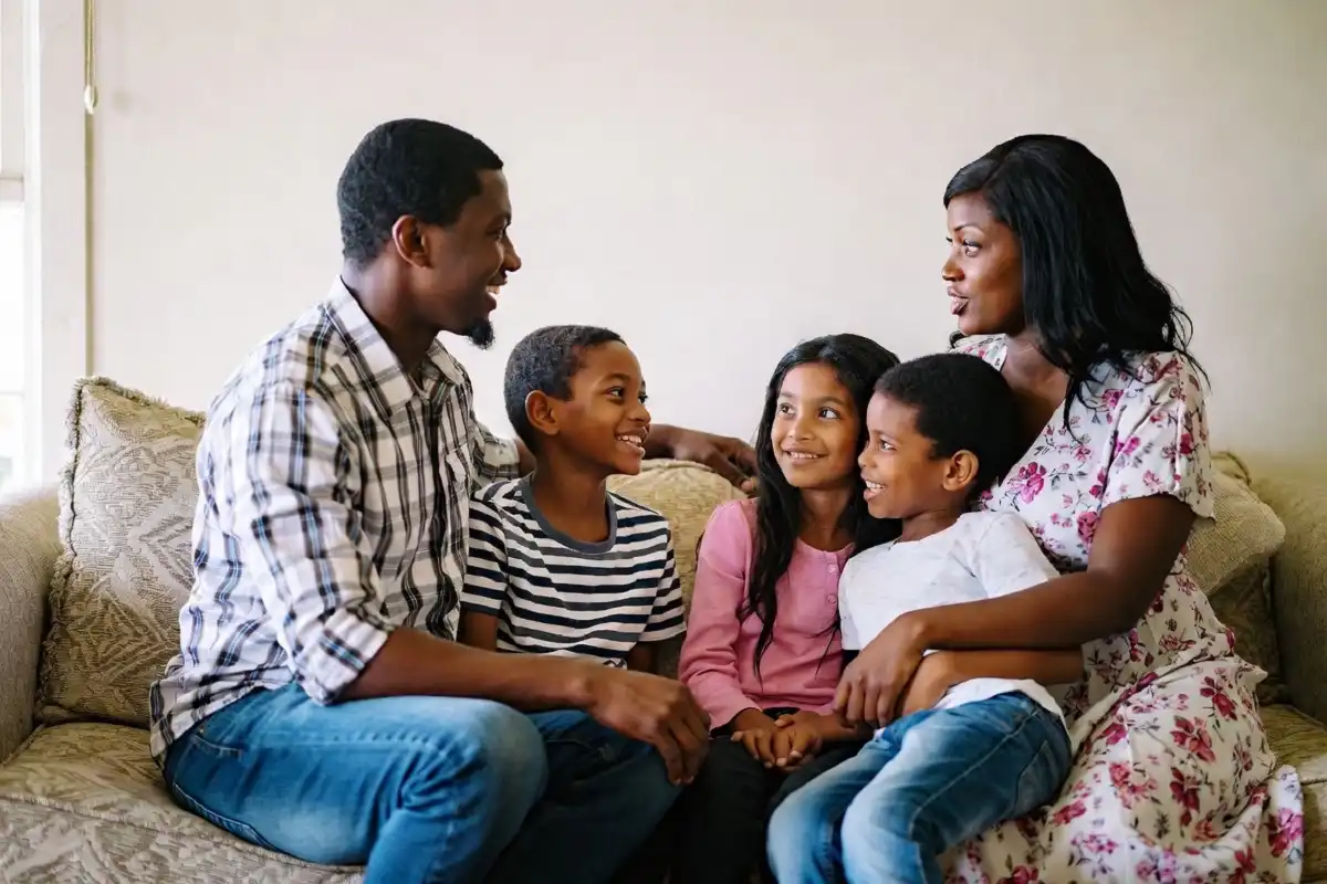 Family sitting together at home offering caring support during recovery