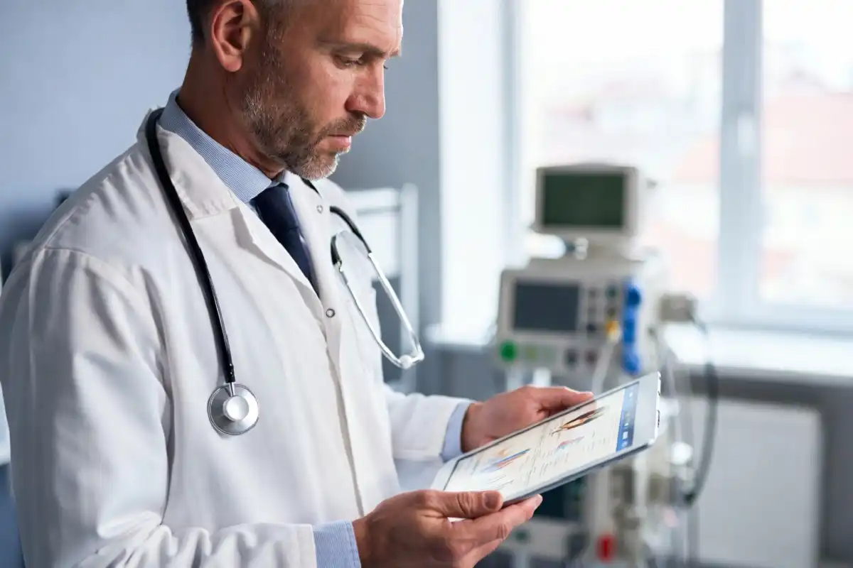 Doctor reviewing medical information on a tablet representing health journalism and professional reporting
