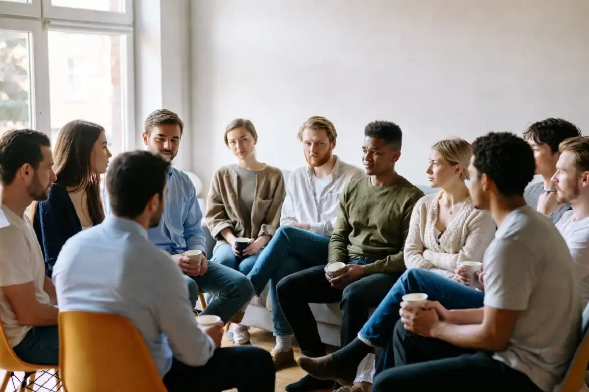 Supportive group therapy session with a counselor and patients sitting in a circle