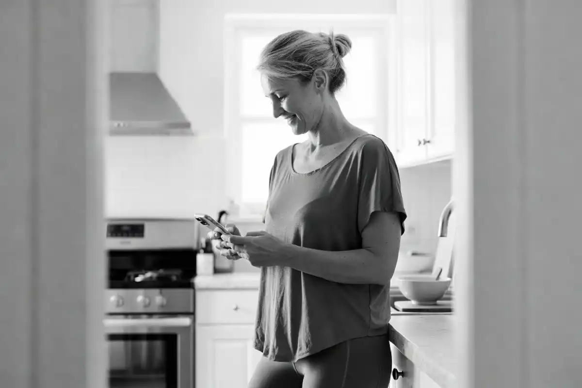 Woman tracking her Mochi Health weight loss progress on a smartphone app