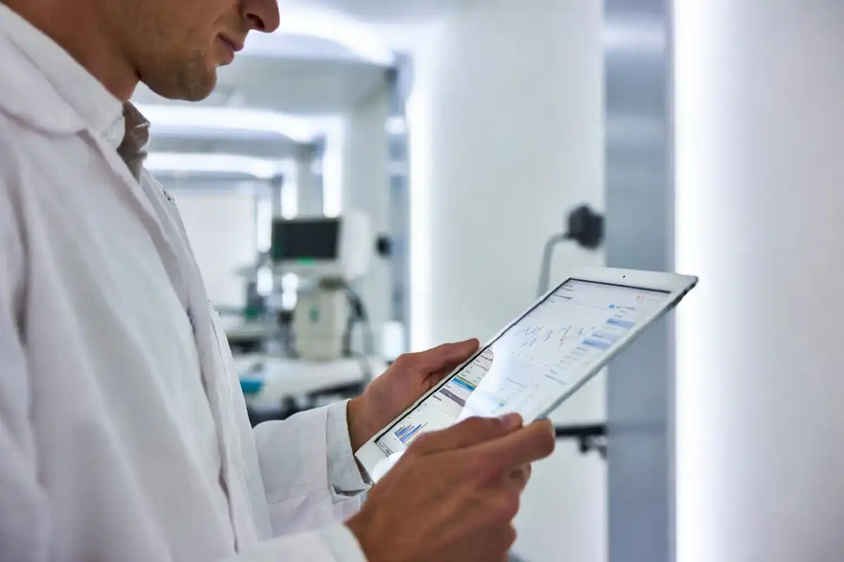 Healthcare professional reviewing digital insurance data on a tablet