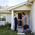 Clinician greeting an older patient at the front door for a Signify Health home visit