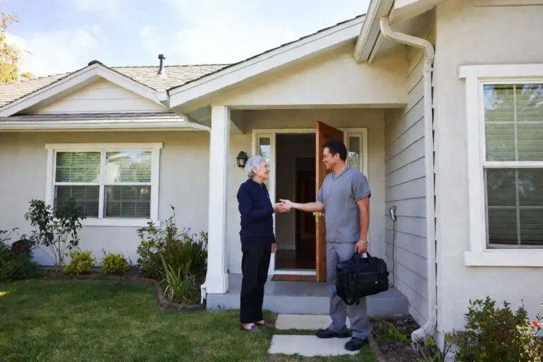 Clinician greeting an older patient at the front door for a Signify Health home visit