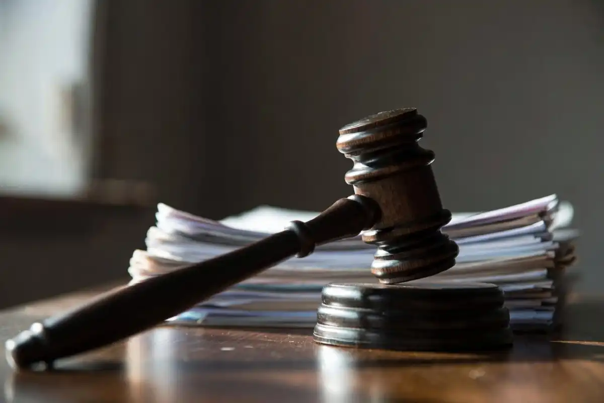 Wooden judge's gavel resting on legal documents symbolizing a court ruling