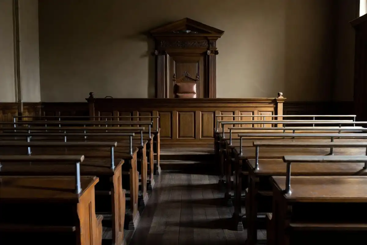 Empty courtroom bench symbolizing a juvenile case heard in the adult court system