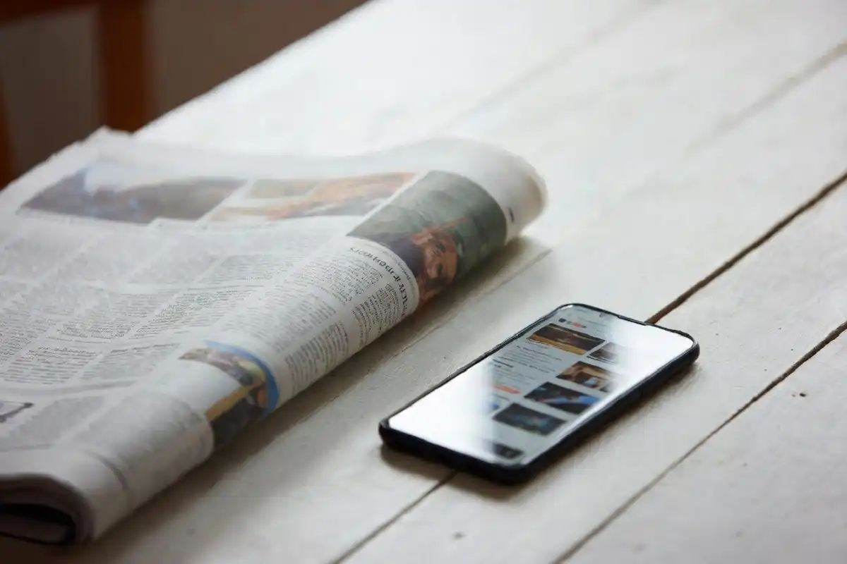 People reading news coverage reflecting public reaction to a court case